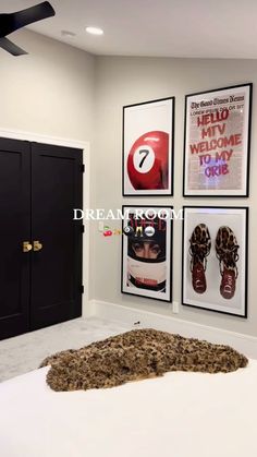 a bedroom with posters on the wall