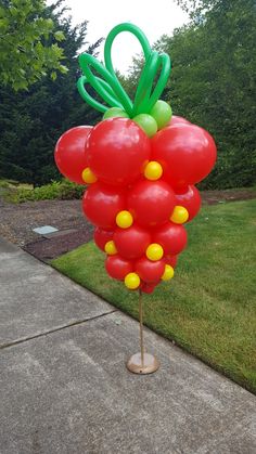 a bunch of balloons that are on a pole