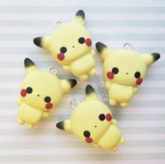 four pikachu charms sitting on top of a table