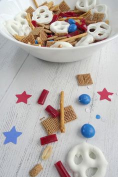 a bowl filled with patriotic treats on top of a white table