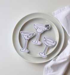 a plate with two glasses on it next to a napkin and some paper towels in the background