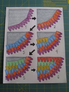 four different colored wings on top of a cutting board with scissors and paper next to them