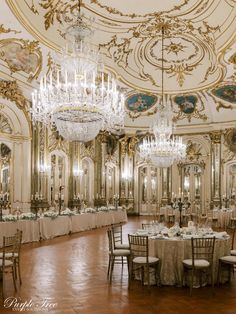 an elegant ballroom with chandeliers and tables