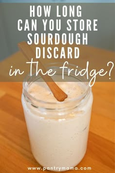 a mason jar filled with sourdough and the words how long can you store sourdough disard in the fridge?