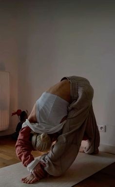 a woman and child doing yoga in front of a radiator on the floor