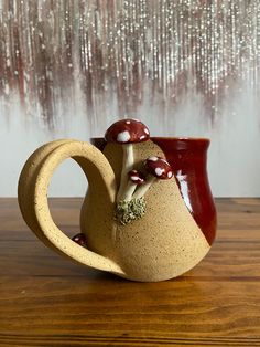 a ceramic vase sitting on top of a wooden table