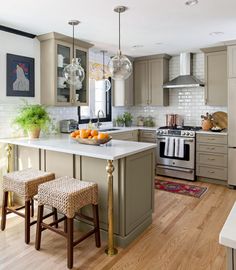 a kitchen with two stools next to an island