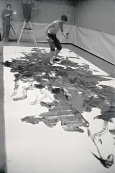 two men are playing tennis on a court covered with plastic bottles and debris in an old photo