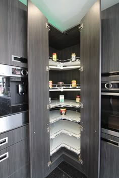 an empty pantry is shown in the middle of a kitchen with stainless steel cupboards