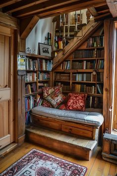 a living room filled with furniture and bookshelves next to a stair case full of books