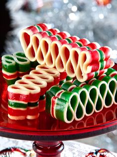 there are many christmas cookies on the plate and one is decorated with candy canes