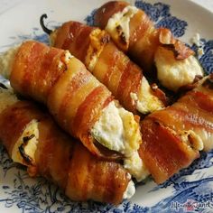 bacon wrapped in cheese on a blue and white plate