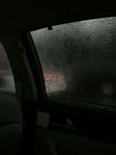 rain is falling on the windshield of a car