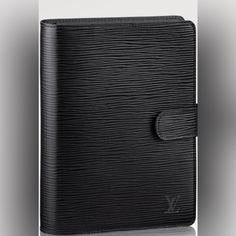 an image of a black leather notebook