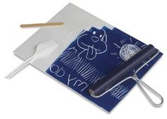 a knife and fork are on top of a piece of blue paper with white writing