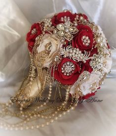 a bridal bouquet with red roses and pearls