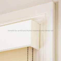 a close up of a white cabinet door with a chain hanging from it's side