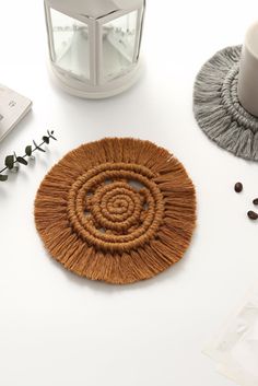 a white table topped with two coasters and coffee beans