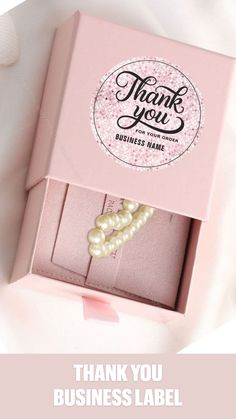 a pink box with pearls on it and the words thank you business label