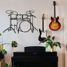 there is a piano and two guitars on the wall