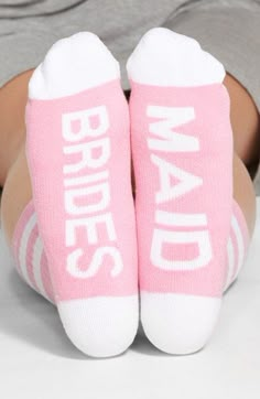 someone wearing pink socks that say brides on the bottom and white lettering below them