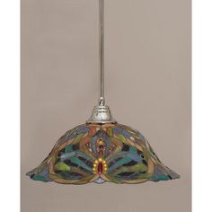 a stained glass light hanging from a ceiling fixture with an ornate design on the bottom