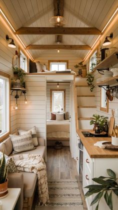 the interior of a tiny house with wood flooring and white walls, along with lots of windows