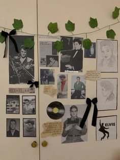 a refrigerator covered in pictures and magnets next to a string with leaves on it