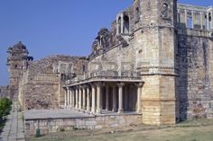 an old stone building with columns and arches