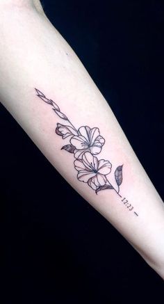 a woman's arm with a flower tattoo on it