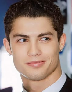 a close up of a person wearing a suit and tie