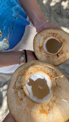 a person holding two pieces of food in their hands