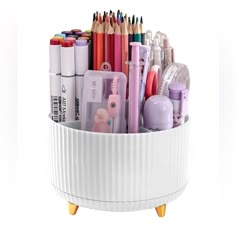 a white container filled with lots of different types of pens and pencils