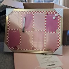 there is a pink and white box with some stickers on the inside of it