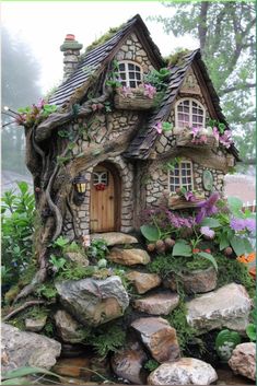 a small house made out of rocks and plants