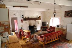 a living room filled with furniture and a fire place next to a stove top oven