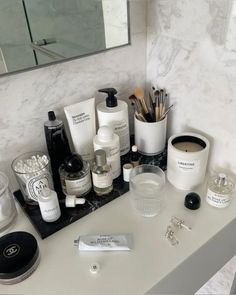 a bathroom vanity with various personal care items on it