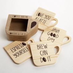 four wooden coasters with words on them