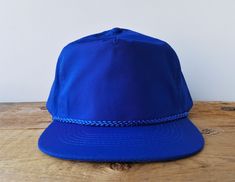 Vintage deadstock blue colored blank hat with rope lined no logo front and adjustable leather buckle strap with embossed brass buckle. Inner terry cloth lined rim adds comfort and softness while wearing.  Made by KC Cap. Circa 1990s Adjustable strap One Size Fits All (Fits most hat sizes 6 7/8 up to 7 5/8) Condition: New, Never Worn Checkout all our vintage blank hats! Click here: https://www.etsy.com/shop/HatsForward?ref=seller-platform-mcnav&search_query=blank ..whenever you're purchasing mult Blank Hats, Strapback Hats, Brass Buckle, Leather Buckle, Ball Cap, Terry Cloth, Hat Sizes, Trucker Cap, One Size Fits All