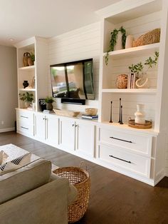 a living room filled with furniture and a flat screen tv on top of a wall