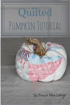 a quilted pumpkin sitting on top of a table next to a sign that says quilted pumpkin tutorial