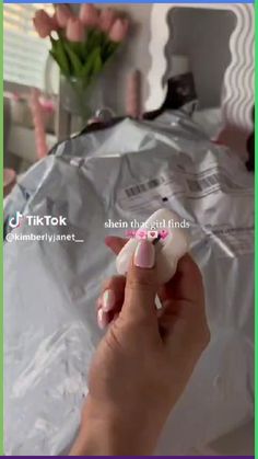 a person holding an object in their hand with the words tiktok written on it