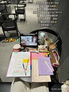 an open notebook sitting on top of a chair next to a stuffed animal and other items