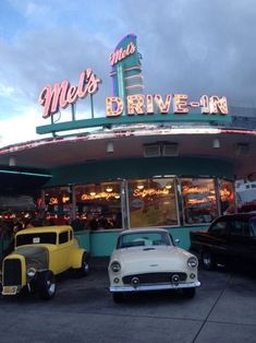 an old car parked in front of a drive - in