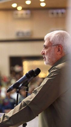 an older man giving a speech at a podium