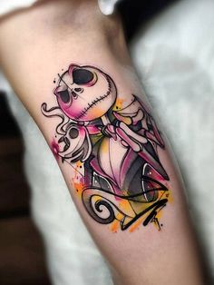 a person with a tattoo on their arm holding a skateboard and wearing a skull mask