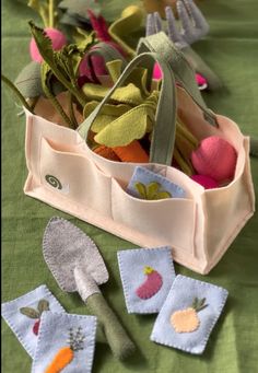 an assortment of garden tools are sitting on a table with green cloths and napkins