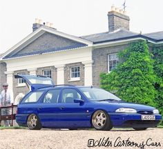 a blue car parked in front of a house