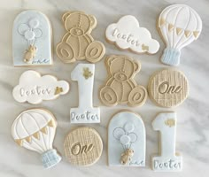 decorated cookies with balloons, hot air balloons and other items for the first birthday party