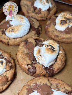 chocolate chip cookies with marshmallows and whipped cream on top in a box